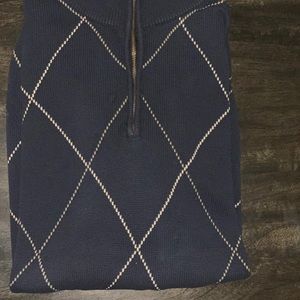 Navy blue and tan sweater. Zip up to the neck, 100% cotton. Dry clean preferred.